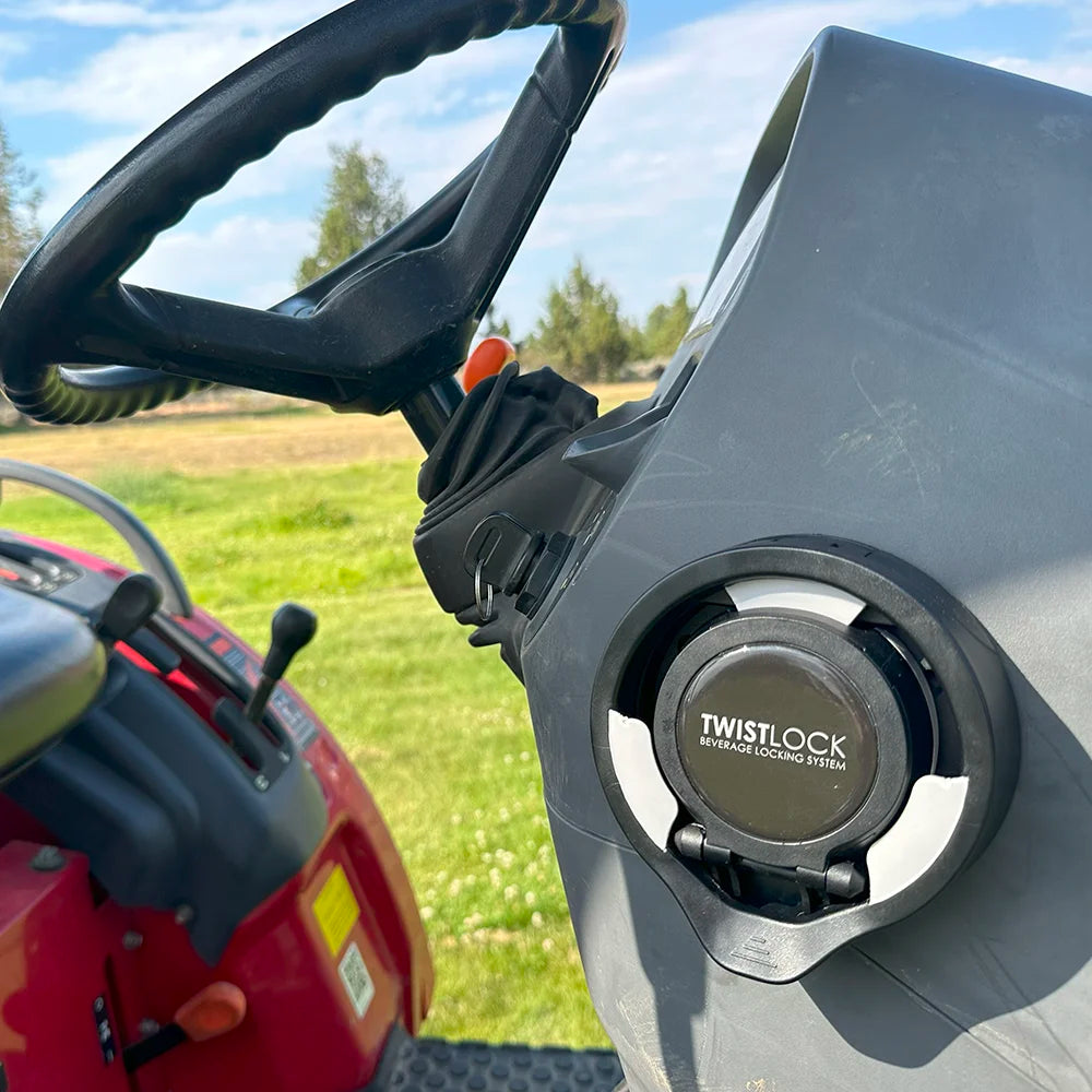 Attachable folding cup holder on a tractor in the closed position.