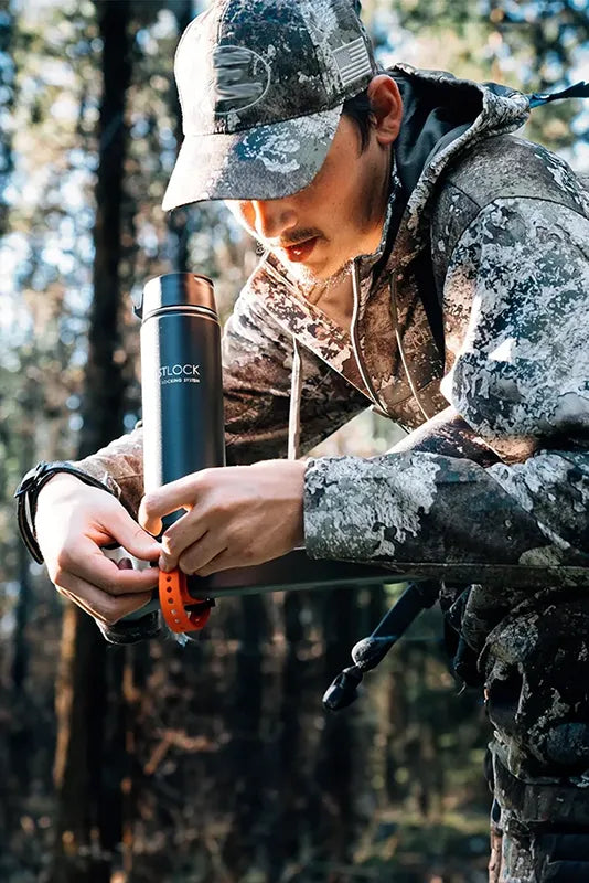 A bow hunter in a tree stand attaching a Bar Mount Locking Cup Holder.