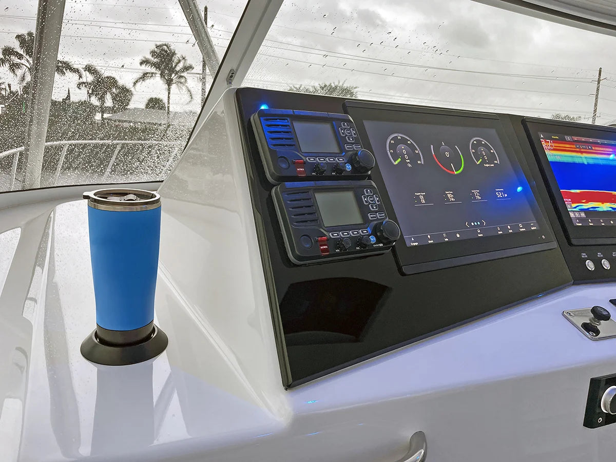 Blue Tumbler and TwistLock Flat Mount attachable adhesive cup holder on the center console of a boat. Spill free and locked in.