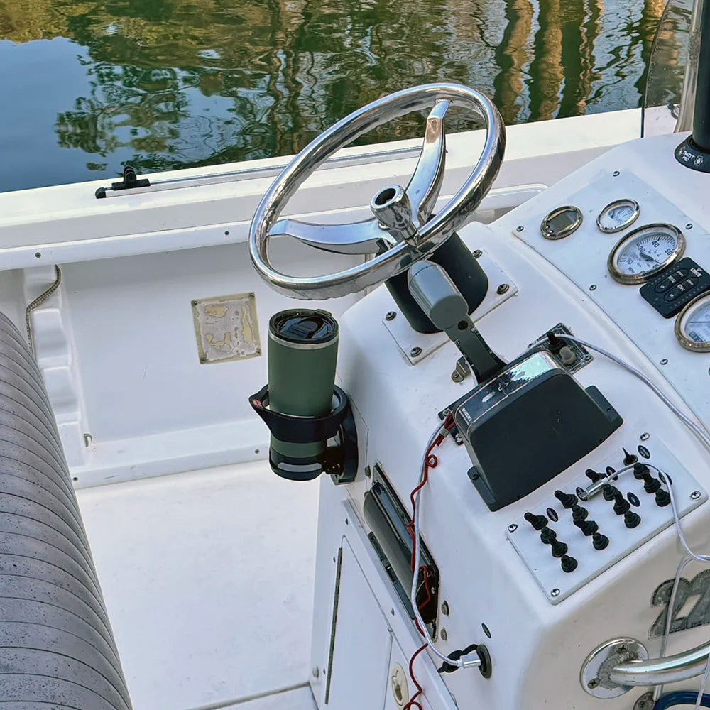 The TwistLock Folding Vertically Mounted Locking Cup Holder and 22oz Insulated Trailhead Green Tumbler on a Center Console Boat.