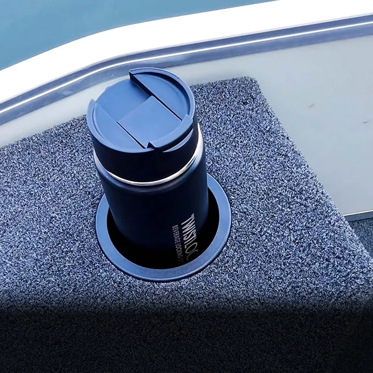 Recessed cup holder on a boat with a canteen locked into it.