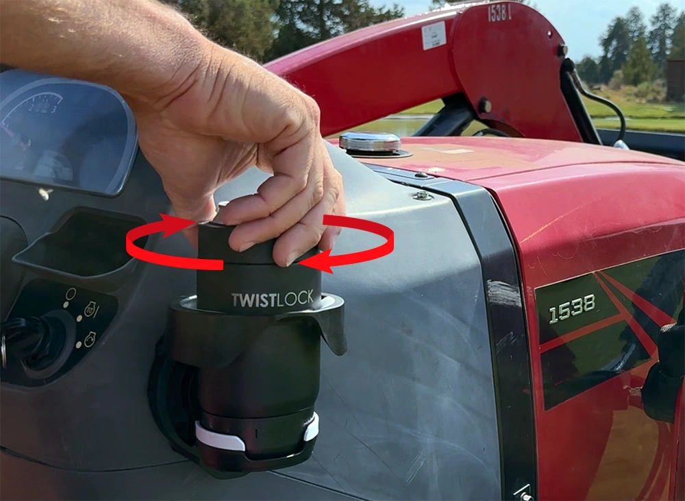 Locking a can cooler into a vertical mount cup holder attached to a tractor.