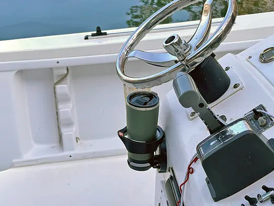 A center console fishing boat with a TwistLock folding cup holder vertically mounted using the adhesive. The wave proof beverage holder is securing a green stainless steel vacuum insulated 22 oz TwistLock tumbler.
