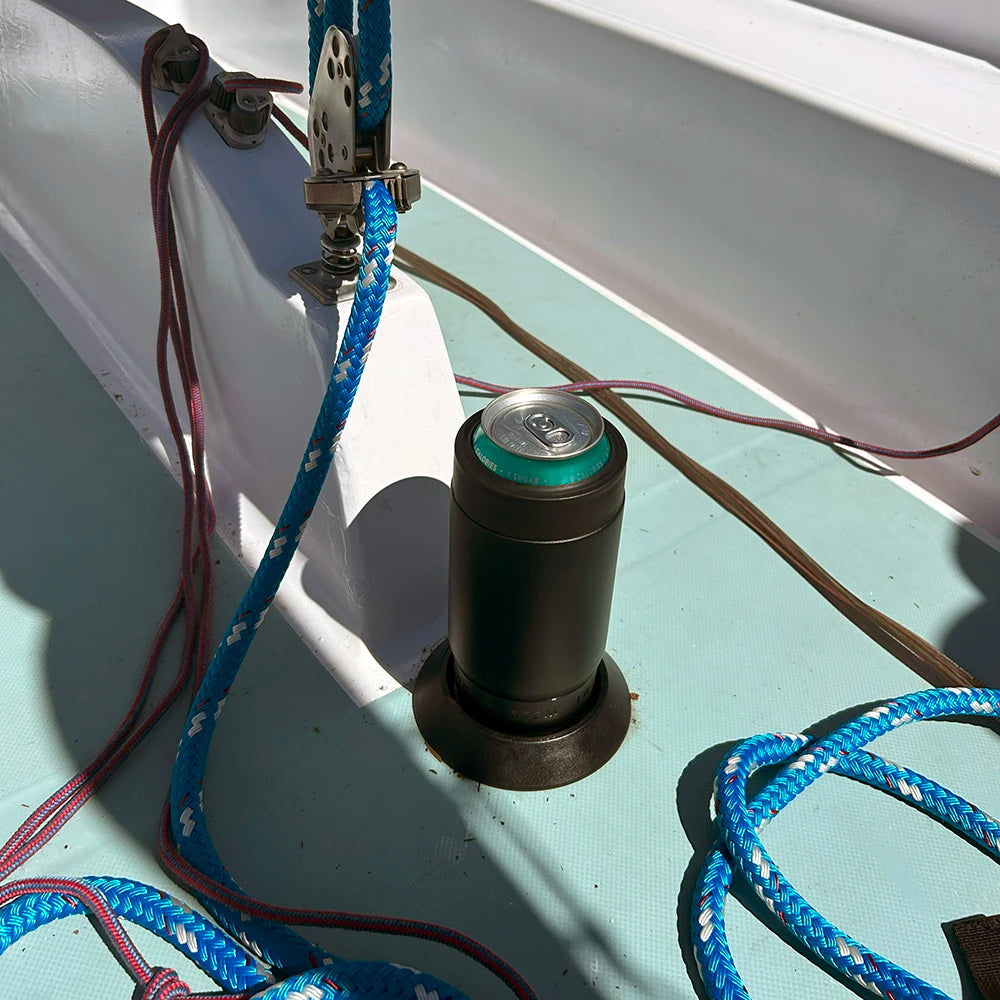 A TwistLock Flat Mount attachable cup holder and insulated can cooler added to the deck of a sailboat using the adhesive.