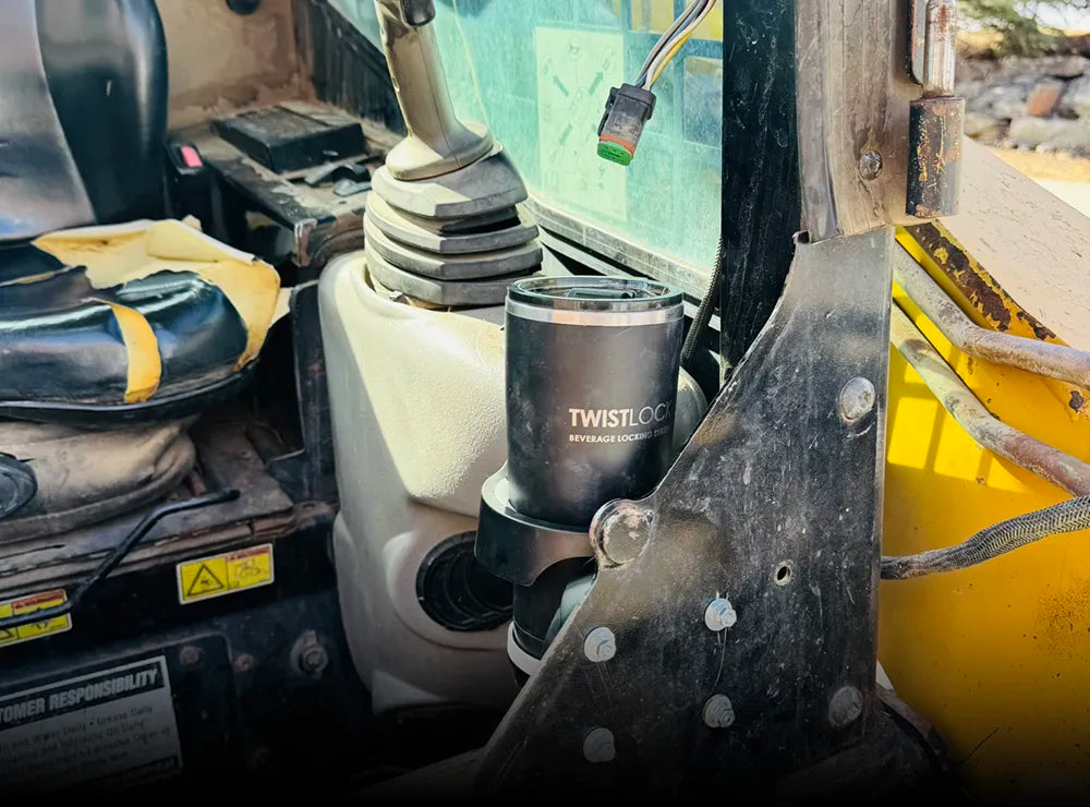 TwistLock Tumbler and Vertical Mount Folding, Locking Cup Holder mounted to the inside of a skid steer using the included adhesive.