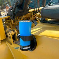 The TwistLock Folding Locking Vertically Mounted Cup Holder attached to the side of a heavy duty yellow industrial forklift.