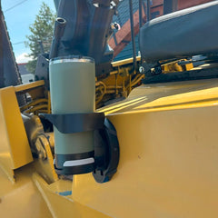 Side view of the TwistLock Vertical Mount Locking Cup Holder attached to the side of a forklift with a green tumbler locked into it.