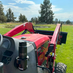 The TwistLock Vertical Mount Locking Cup Holder attached to the side of a red tractor with a obsidian black insulated canteen securely locked in.