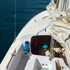 A boat with a TwistLock Vertical Mount marine cup holder attached near the cuddy with an insulated canteen securely locked in.
